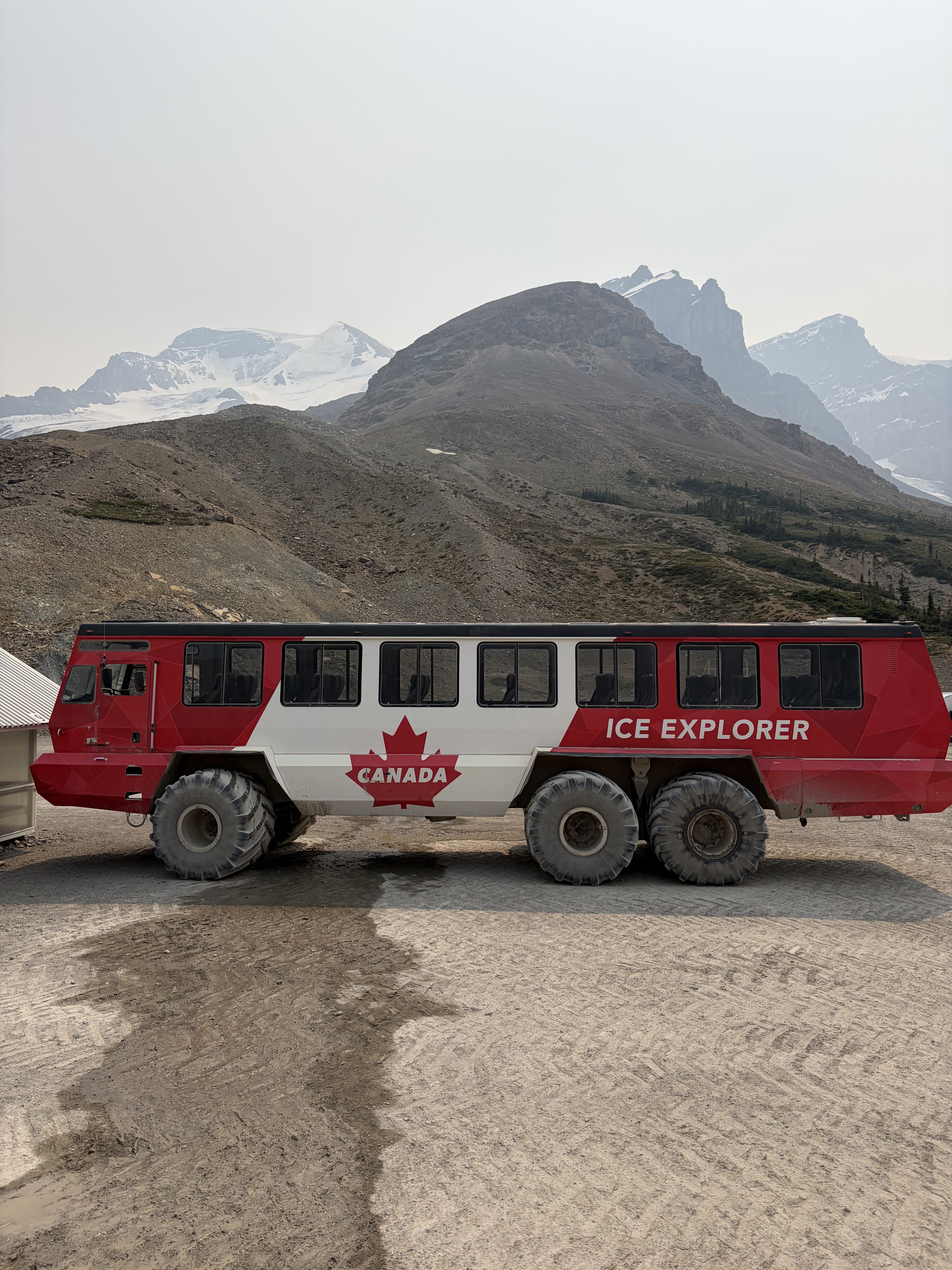 A red and white Ice Explorer truck with a maple leave painted on it at the Columbia Icefield.