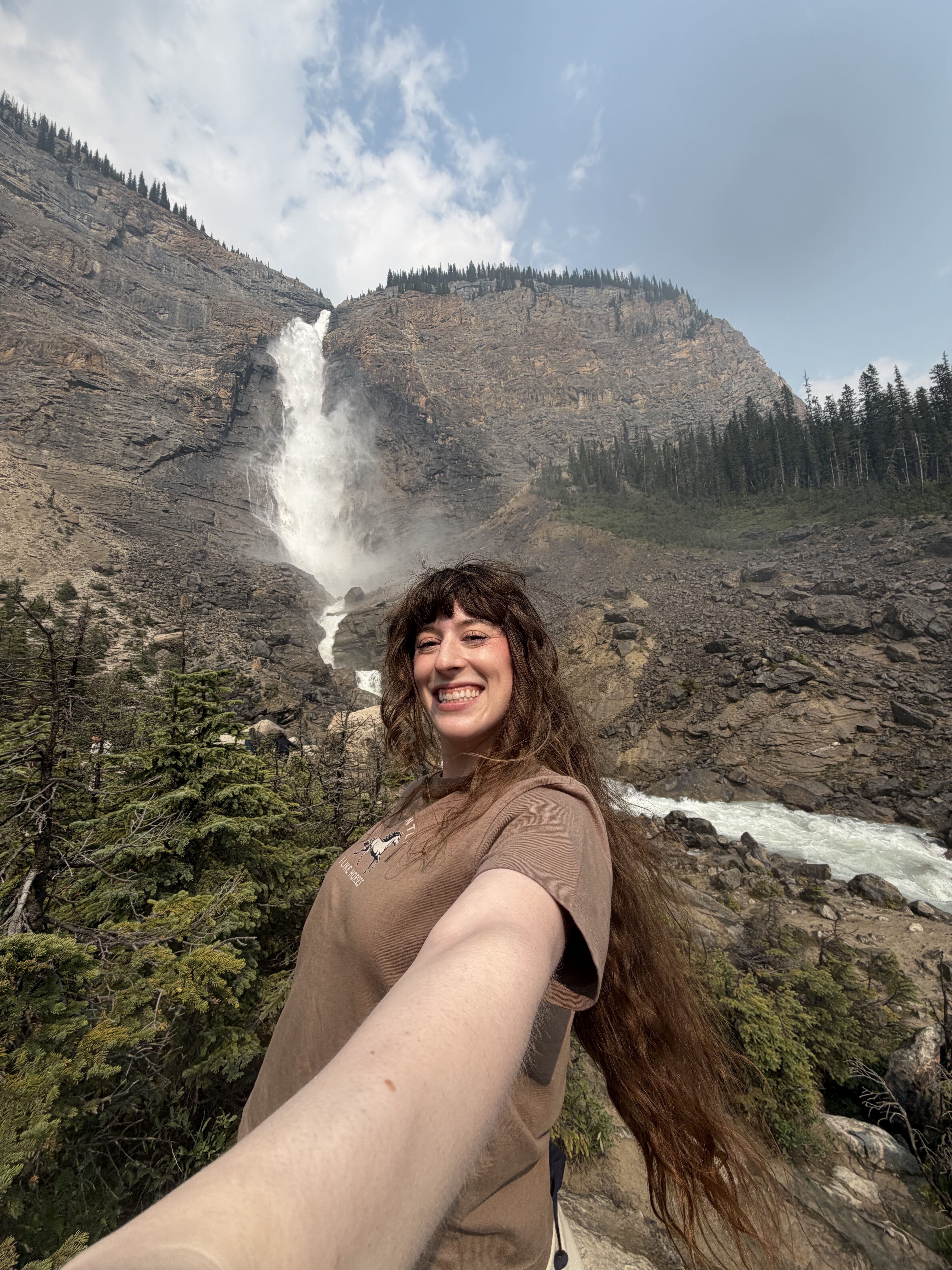 Bella taking a wind-blow selfie in front of Takakkaw Falls, Yoho National Park.